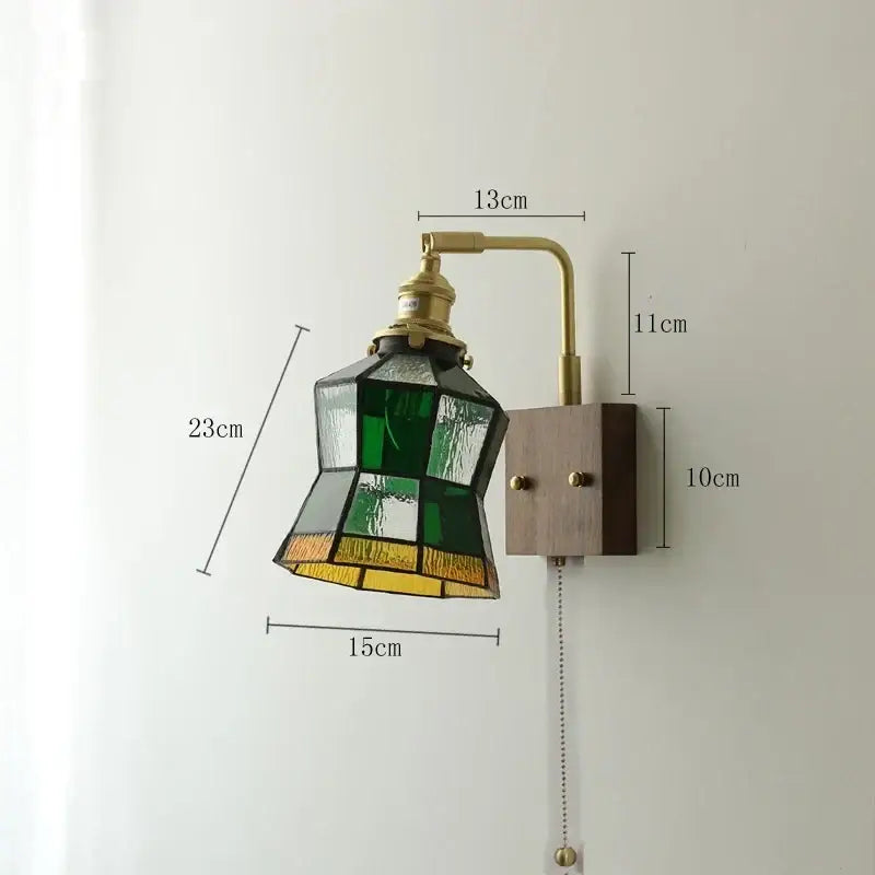Vintage-style led wall light with brass arm, wooden base, and green yellow stained glass shade for living room use