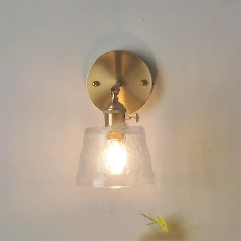 Brass clear glass led wall sconce with pull chain featuring a brass finish and textured decorbites clear glass shade