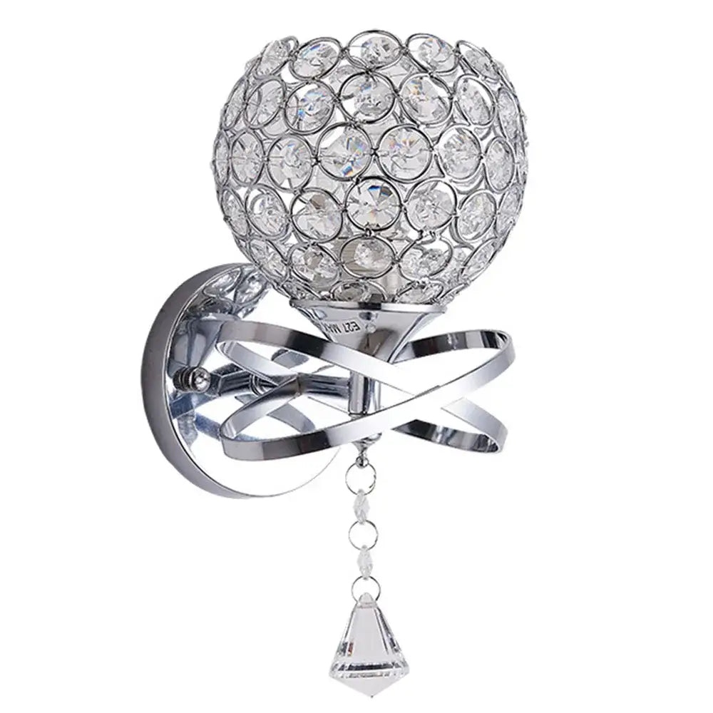 A sparkling chrome brass crystal glass wall sconce with a spherical globe and diamond pendant for bedroom lighting