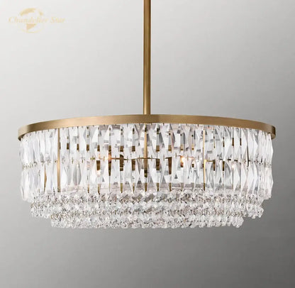 A modern decorbites crystal round pendant chandelier with gold brass frame and clear faceted glass prisms for dining room