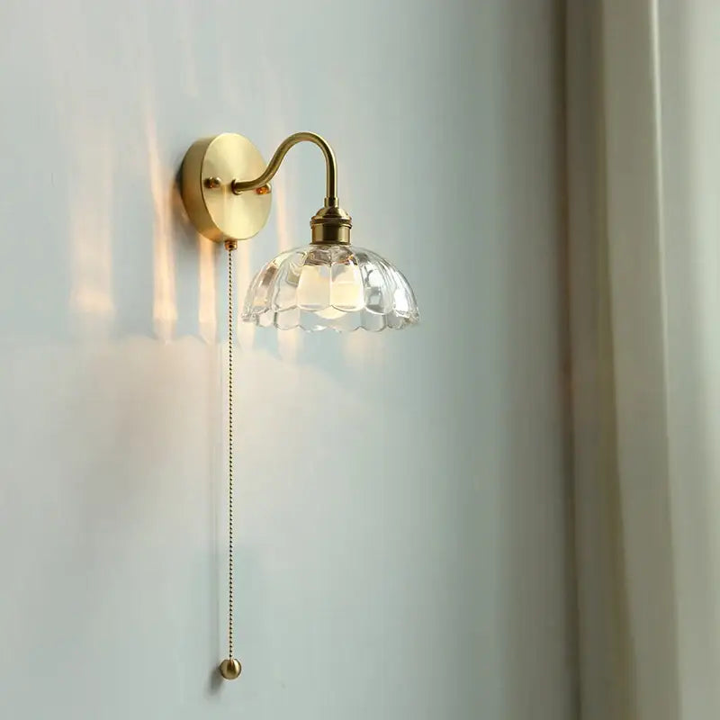 Vintage-style brass glass copper led wall sconce with clear faceted shade and ornate pull chain for bedroom mirror