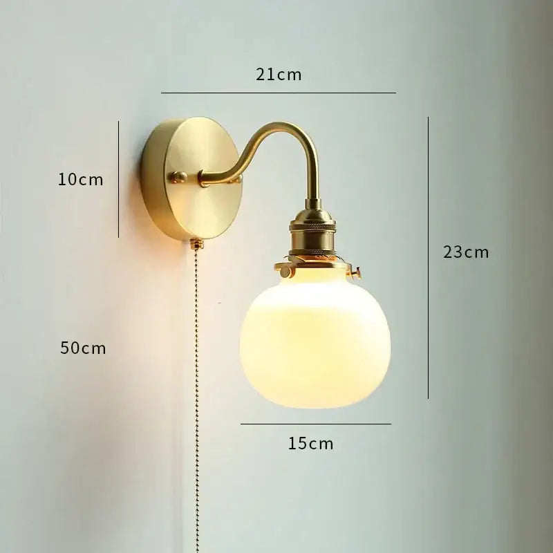 Brass glass copper led wall sconce with frosted globe and curved arm featuring pull chain for bedroom mirror lighting