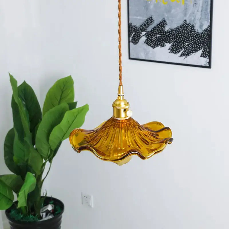 Amber-colored ruffled glass pendant lamp with brass glass lotus design and twisted cord for dining room decorbites brass glass