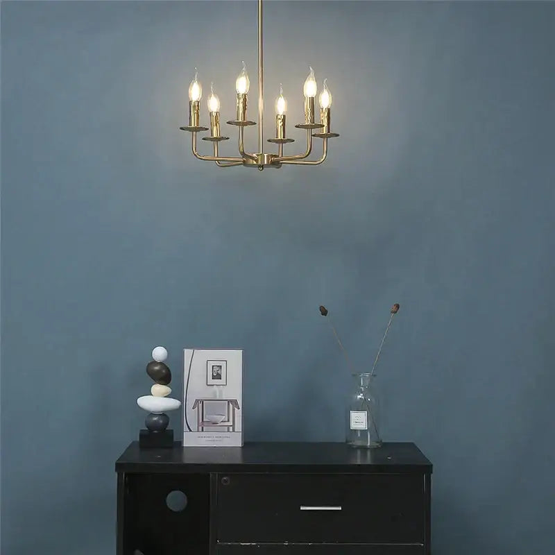 Brass iron art chandelier with six lit candle-style bulbs for dining room decorbites iron art chandelier lights