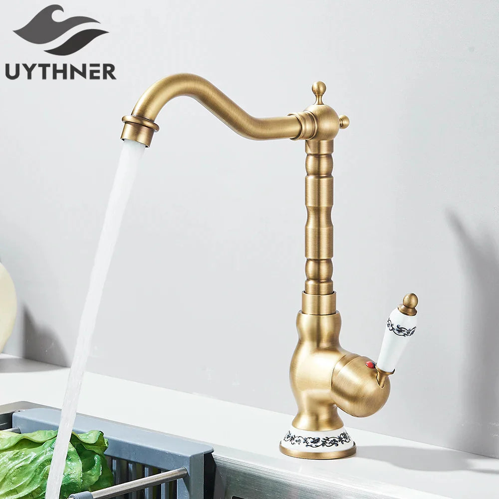Antique brass deck mounted kitchen faucet with rotating neck curved spout and ceramic handle with black floral patterns