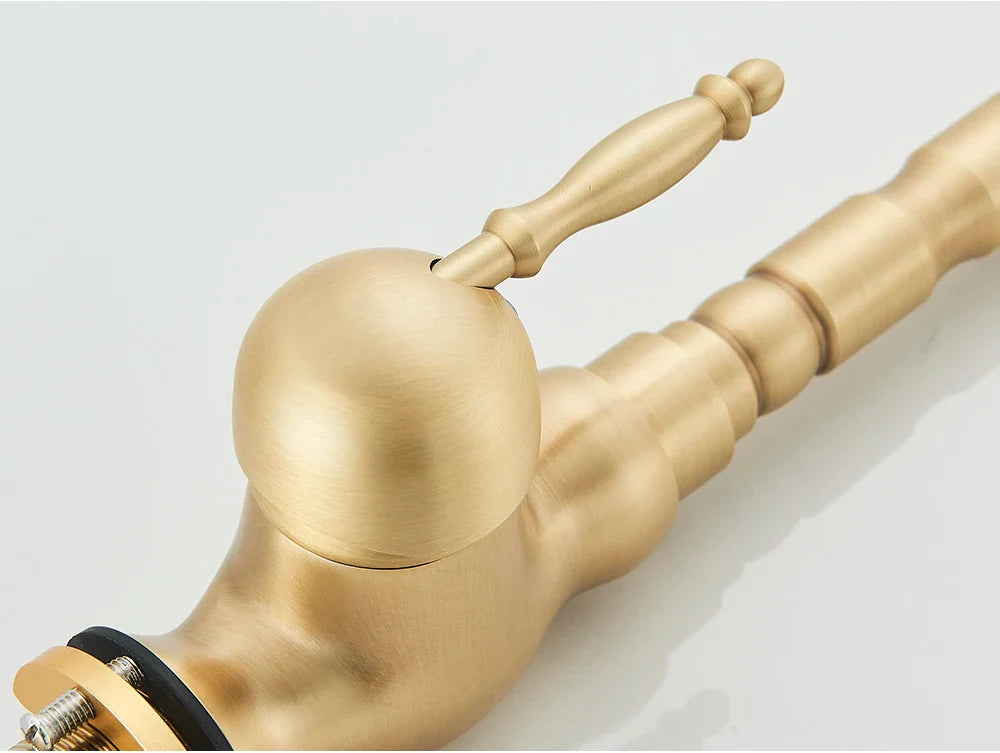 Brass kitchen faucet with rotating neck, deck mounted, featuring a brass finish, spherical spout, and ornate segmented handle