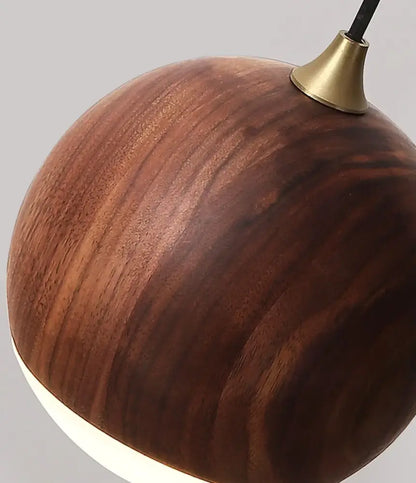 A sleek round wooden wall lamp with warm brown led walnut wood finish and brass hardware for bedroom decorbites