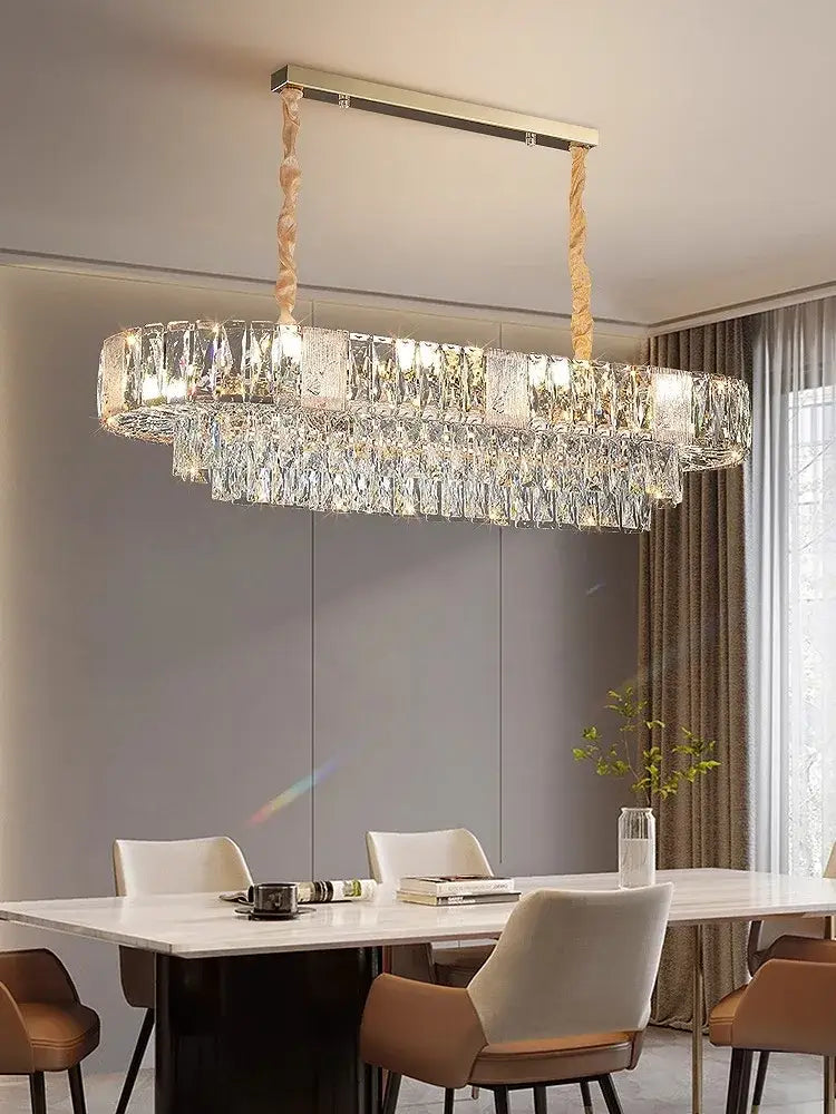 A modern brass multi tiered decorbites crystal ceiling chandelier with gold frame and cascading crystal prisms