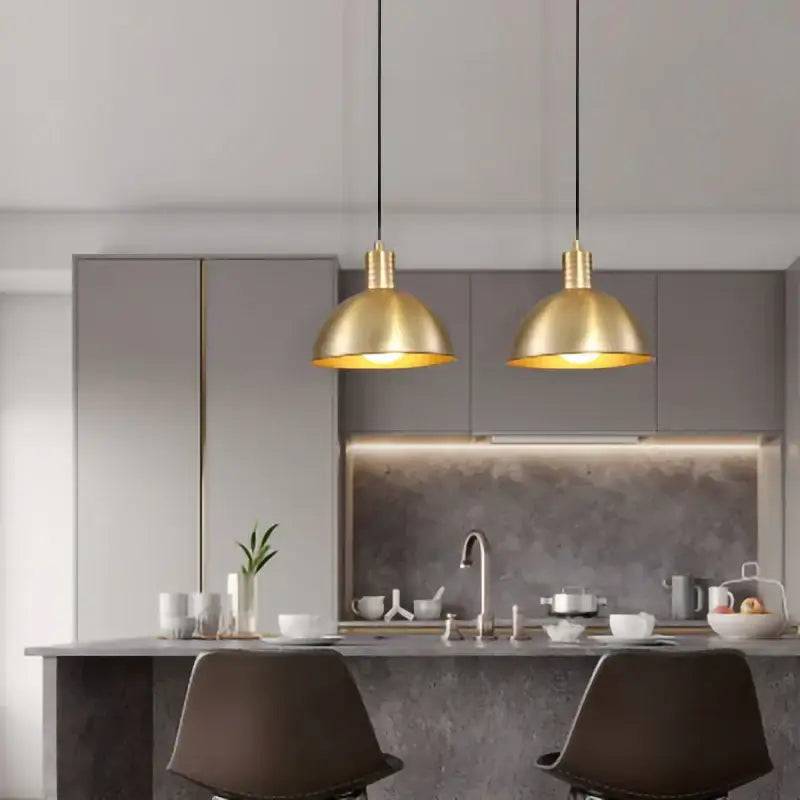 Two elegant brass nordic simplicity e27 led pendant lights with dome design hang above the kitchen island