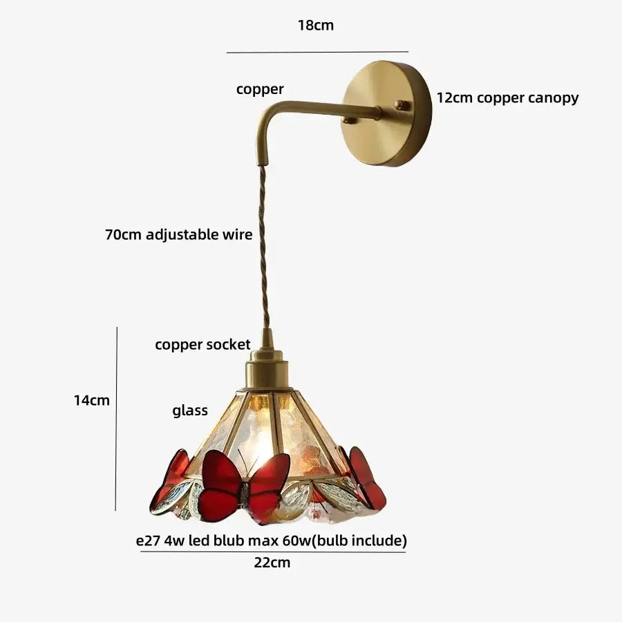 A vintage-style brass wall light fixture with a copper base and stained glass orange butterfly shade for bedroom use