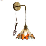 Brass orange butterfly stained glass wall light fixture with amber accents for bedroom sconce lighting