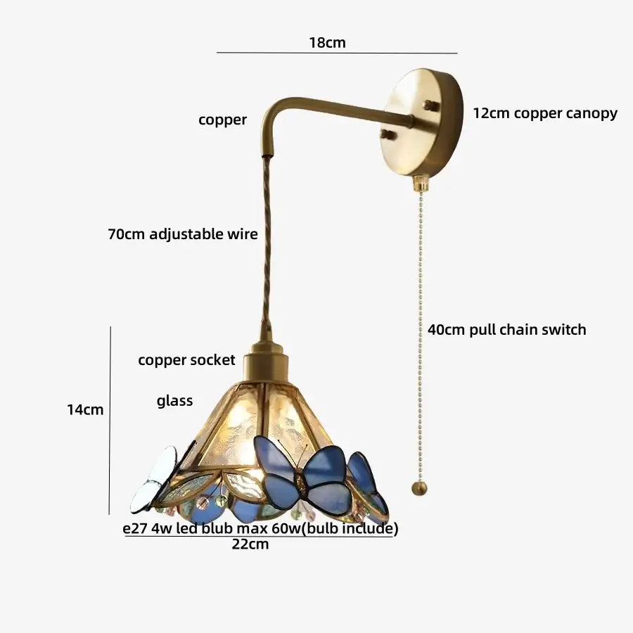 Antique brass-finished copper wall light fixture with blue and white butterfly stained glass shade for bedroom use