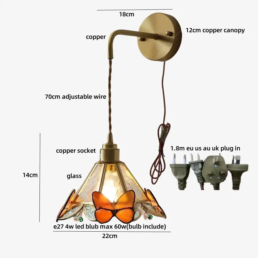 Vintage-style brass wall light fixture with a copper base and orange butterfly stained glass shade for bedroom decor