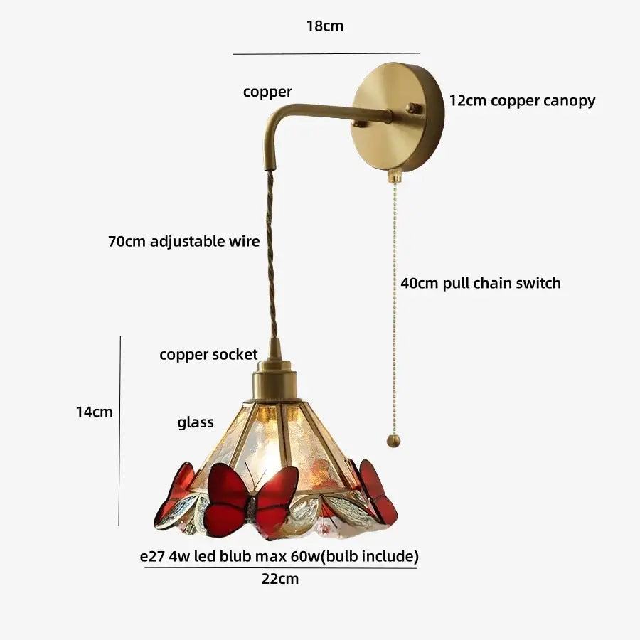 Antique brass-finished wall light fixture with stained glass shade featuring red and clear butterfly motifs for bedroom use