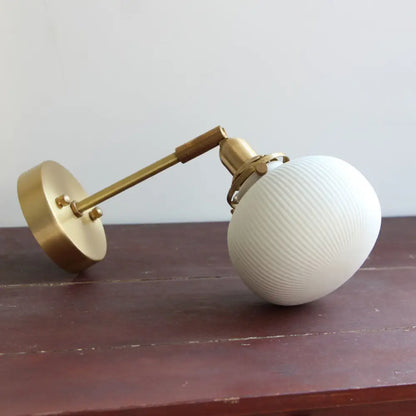 DecorBites™ Brass Pivot Joint Foyer Sconce: Round Ribbed Glass Wall Light with White Simplicity (1 Bulb)