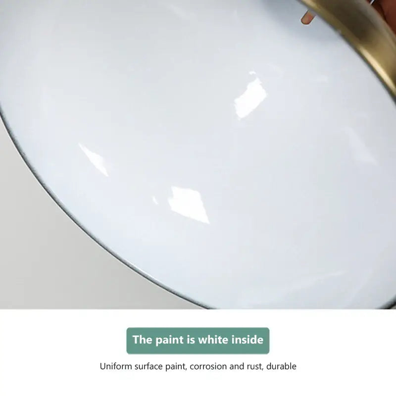 White enamel bowl with glossy interior and gold rim under brass retractable electric 275w food heat pendant light