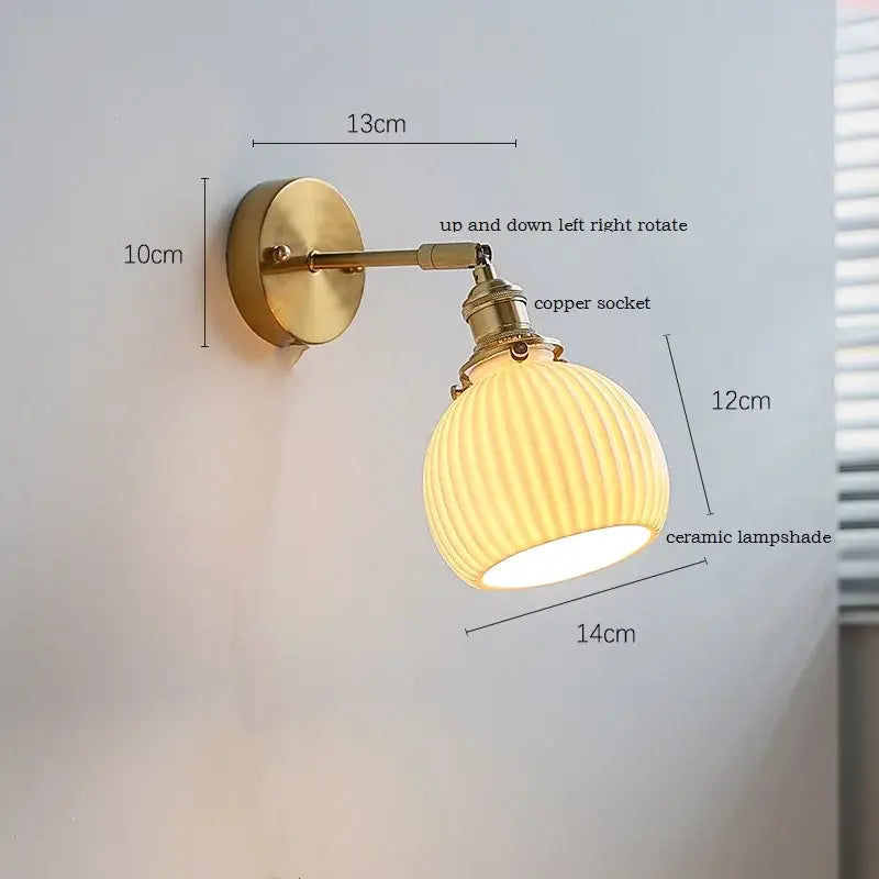 Vintage-style brass wall sconce with ribbed decorbites ceramic lampshade and iron arm for bedroom lighting