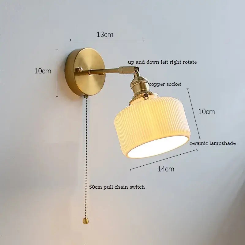 Brass ribbed decorbites ceramic wall sconce with iron arm and cream ribbed lampshade featuring 50cm pull chain switch