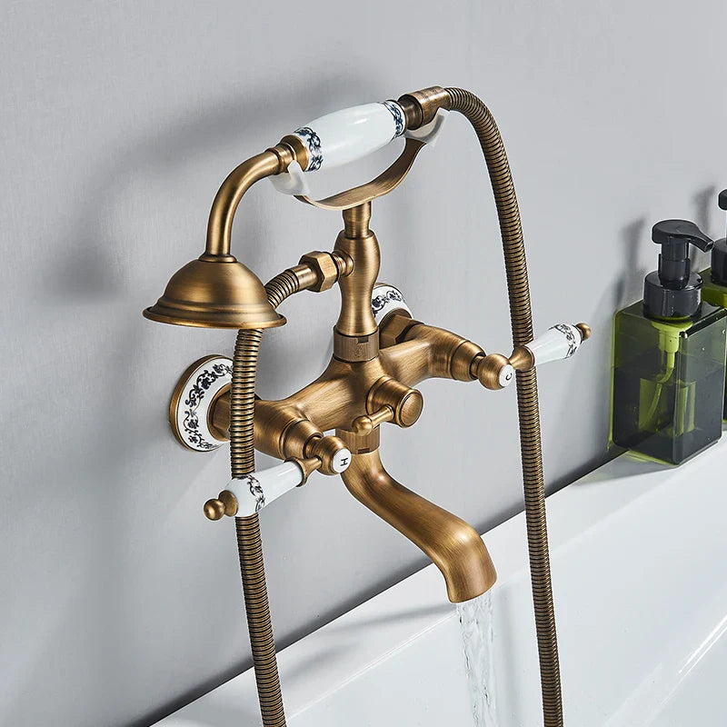 Antique brass shower faucet wall mount with white ceramic handles featuring black floral patterns and cold water control