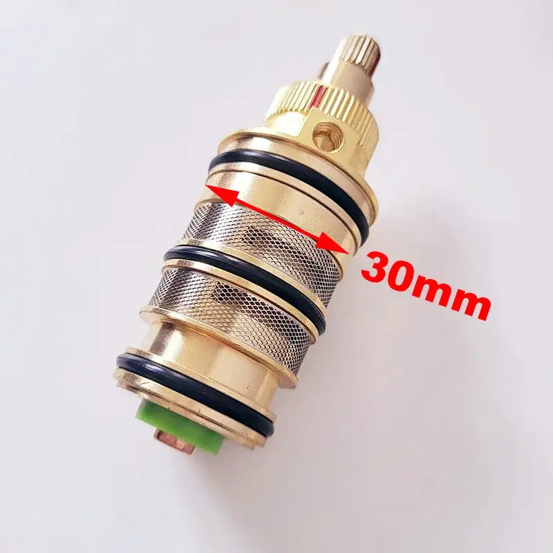Gold-colored brass thermostatic mixer cartridge with mesh pattern black seals and green base for decorbites brass thermostatic valve