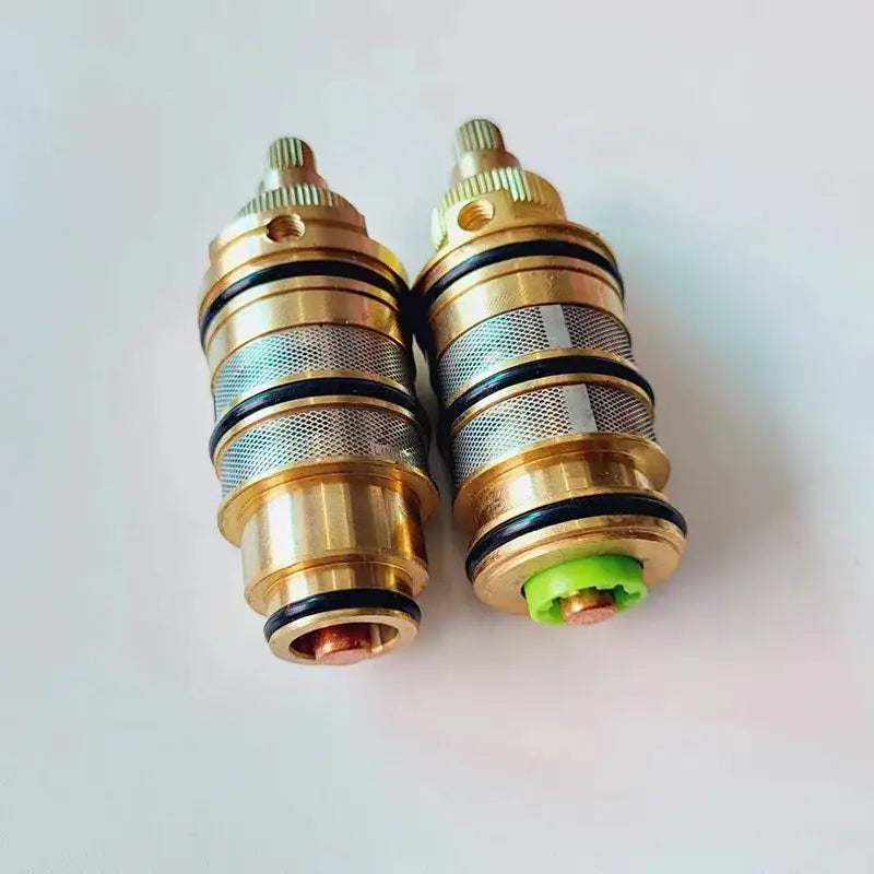 Two brass thermostatic mixer cartridges with meshed bodies and black seals decorbites brass thermostatic valve