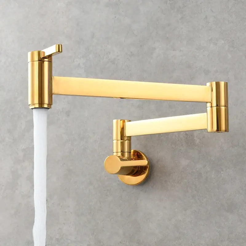 Brass wall mounted pot filler kitchen faucet with a gold-colored sleek extendable articulated gooseneck arm