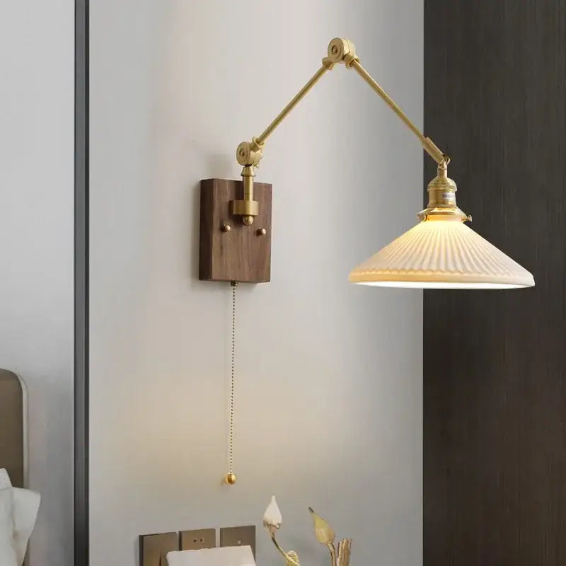 Brass and walnut copper swing arm led wall sconce with adjustable brass finish and ribbed off-white glass shade for bedroom lighting