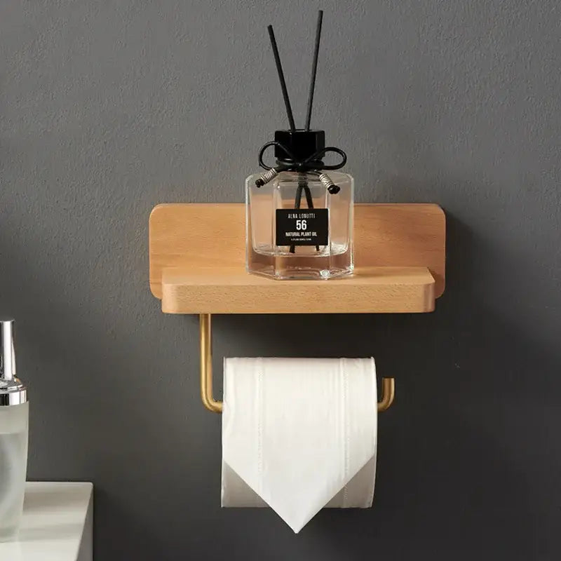 Brass and wood toilet roll holder stand featuring a gold-toned holder and light wood shelf for bathroom use