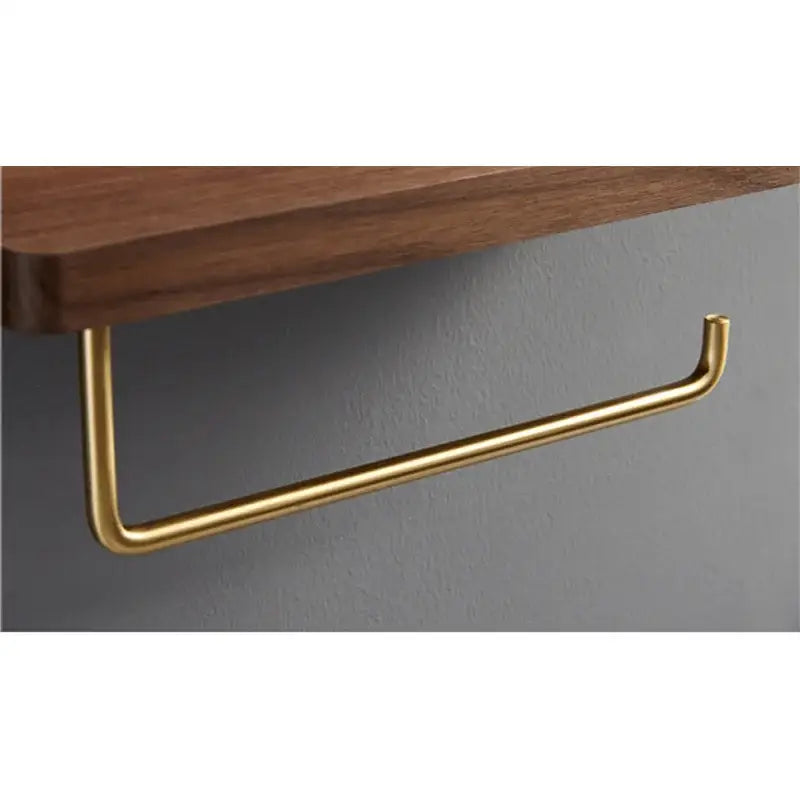 Brass and wood toilet roll holder stand with gold-toned metal towel rack and minimalist design for bathroom use