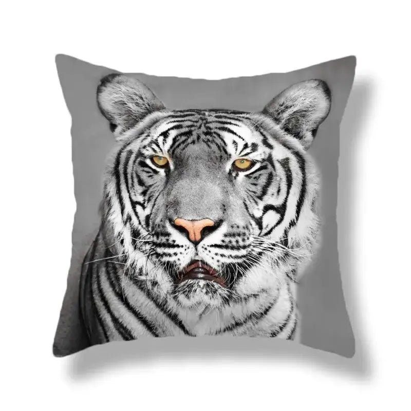 Gray throw pillow with a brave tiger pattern print featuring a white tiger with yellow eyes for living room decor