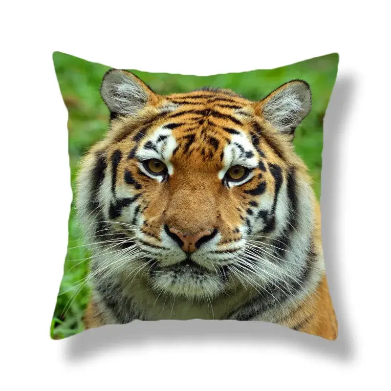 Square throw pillow with brave tiger pattern print featuring vivid orange and black tiger face on green background