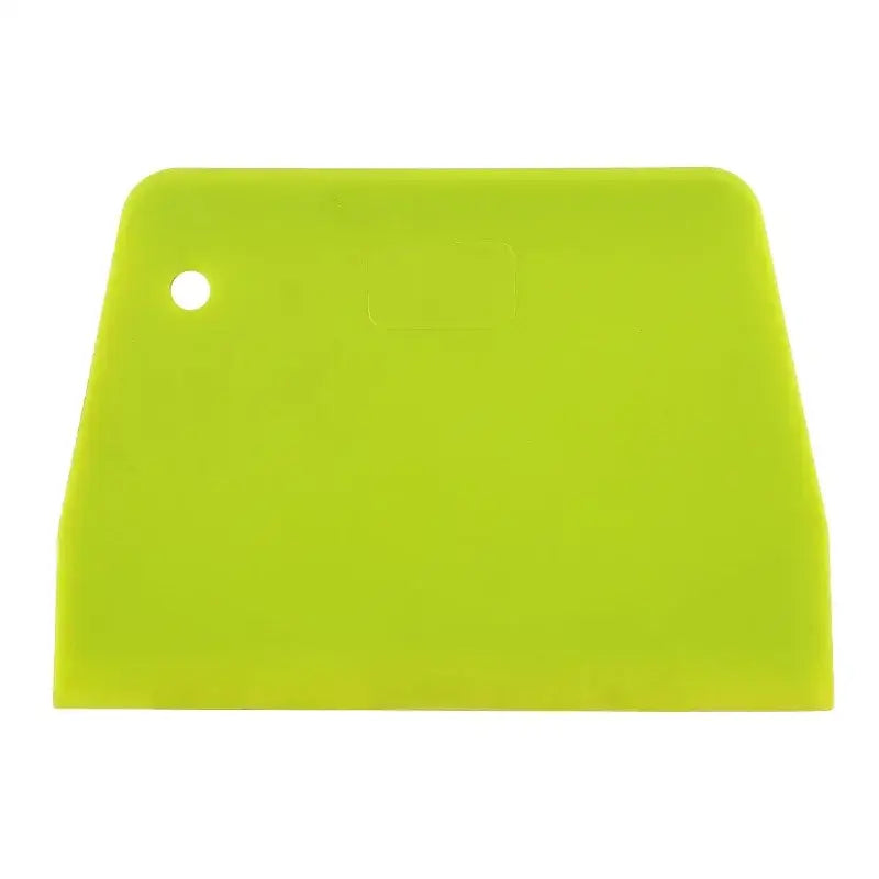 Bright green silicone spatula dough cutter with rounded handle and hole for decorbites cake spatula use