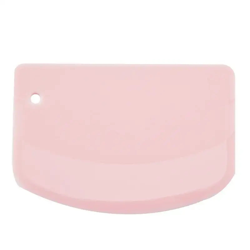 Pink silicone decorbites cake spatula with rounded edge and hole used as cake spatula dough cutter tool