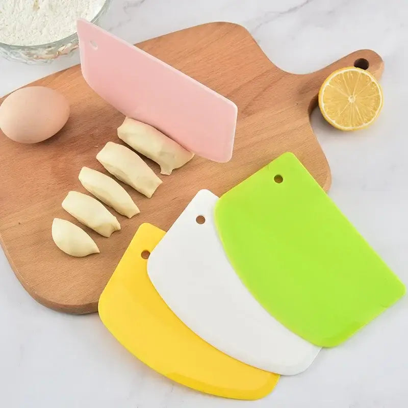 Set of four colorful silicone spatula dough cutters in pink green white and yellow for baking decorbites cake spatula use