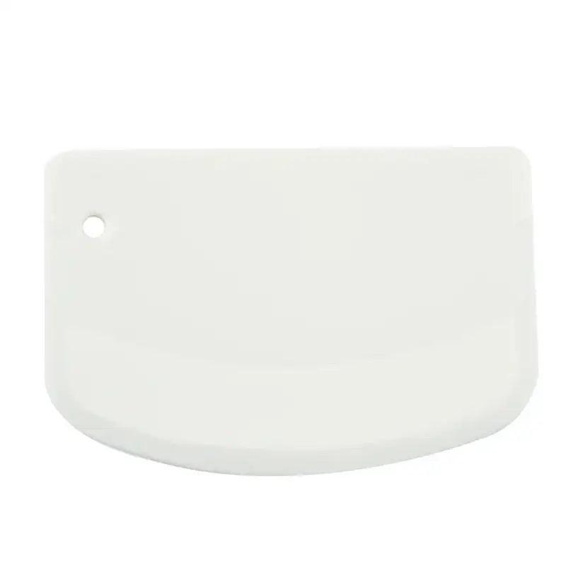 White silicone pastry scraper with rounded edge and hanging hole used as a spatula dough cutter decorbites cake spatula