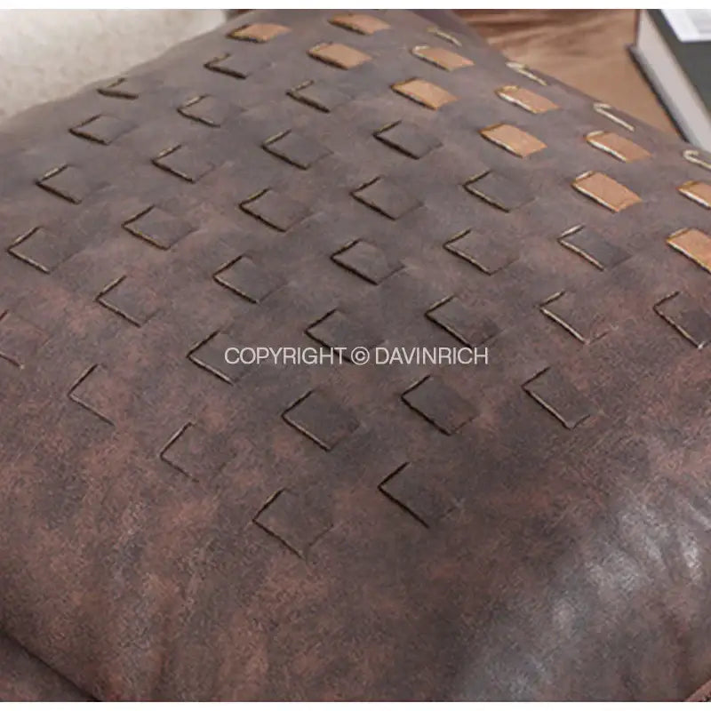 Brown leather cushion cover with woven tan rectangular accents featuring brighton cross stitch design for living room
