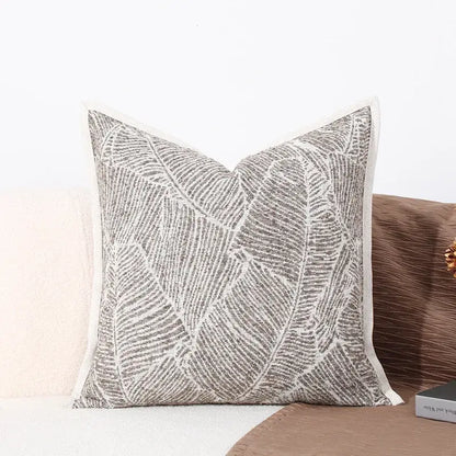 Gray and white embroidered leaf-patterned cushion cover with textured fabric finish for brighton cross stitch collection