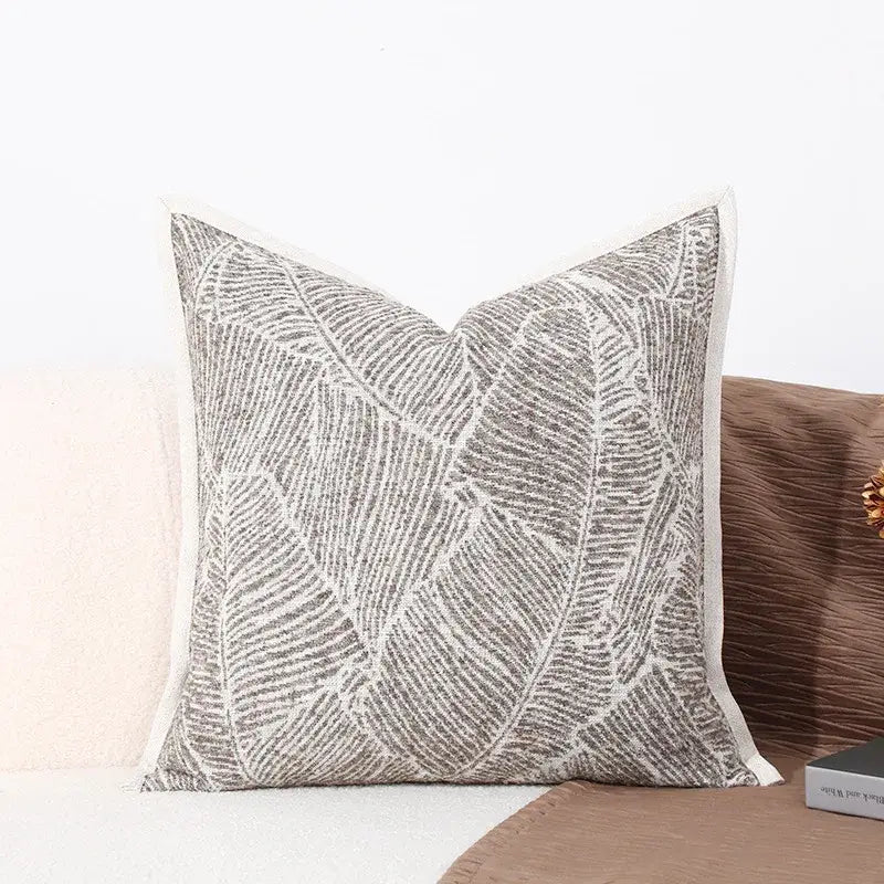 Gray and white embroidered leaf-patterned cushion cover with textured fabric finish for brighton cross stitch collection