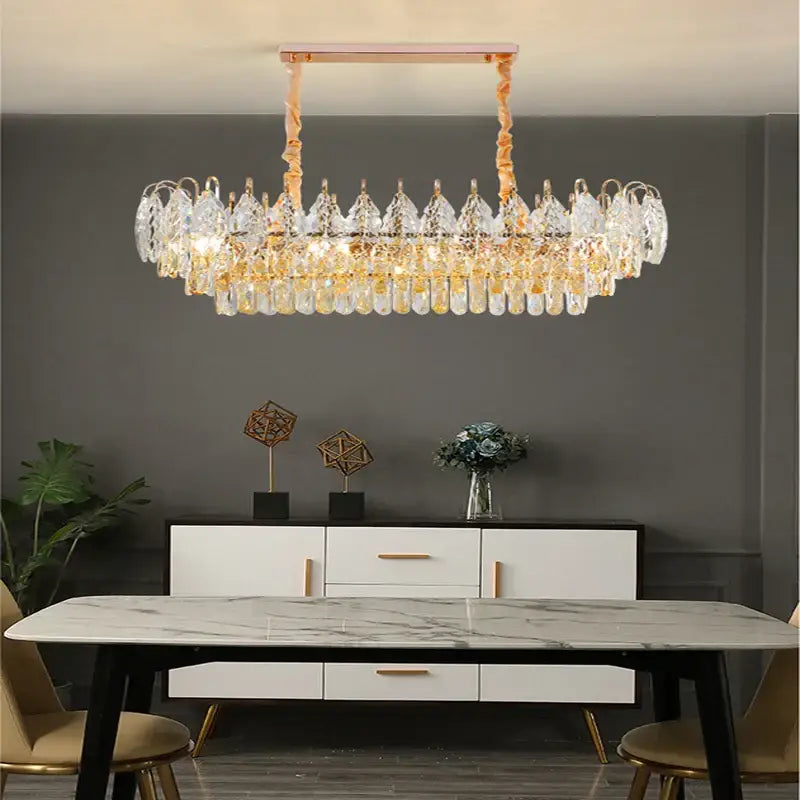 A modern rose gold decorbites brilliance crystal chandelier with clear crystal droplets and gold-toned accents for living room light