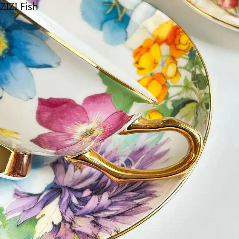 A delicate porcelain teacup with a gold rim and handle featuring a brilliant flowers pattern of vibrant colors