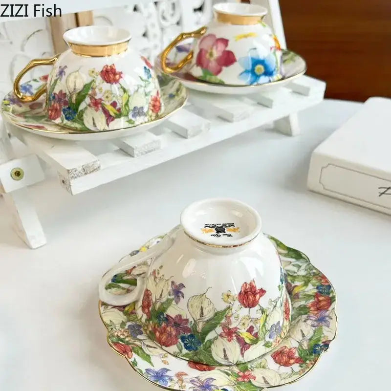 Delicate porcelain teacup and saucer with brilliant flowers pattern in vibrant reds blues purples and gold trim