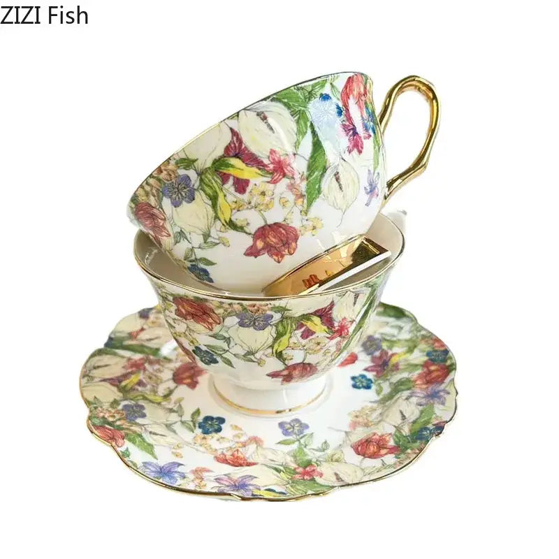 A porcelain teacup and saucer dining room set with a brilliant flowers pattern in red pink blue and green with gold trim