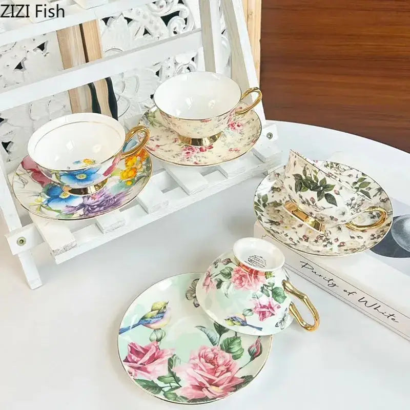 Elegant porcelain teacups and saucers with brilliant flowers pattern in soft pastels and gold rims for dining room use
