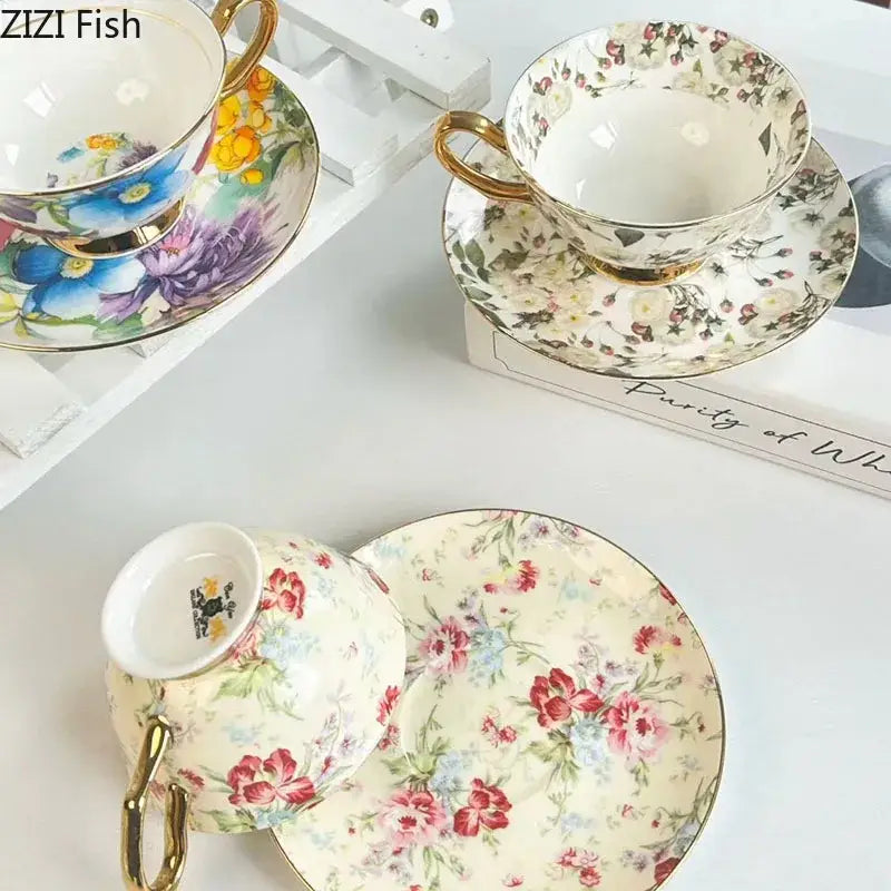 Delicate porcelain teacup and saucer dining set with brilliant flowers pattern in soft pastels and gold rims