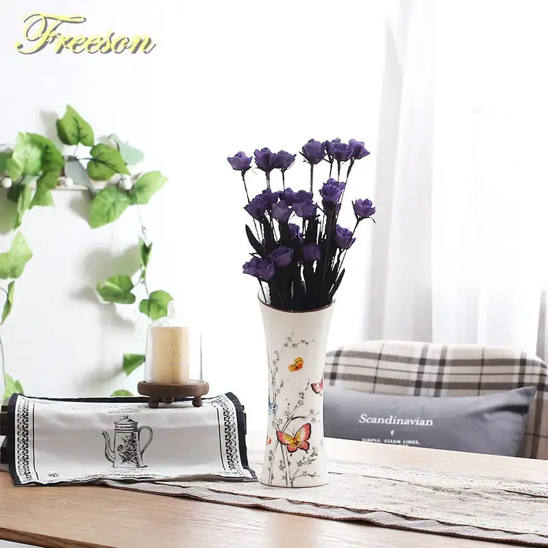 White ceramic bird butterfly porcelain vase with delicate decals holding dried purple roses for living room decorbites decor