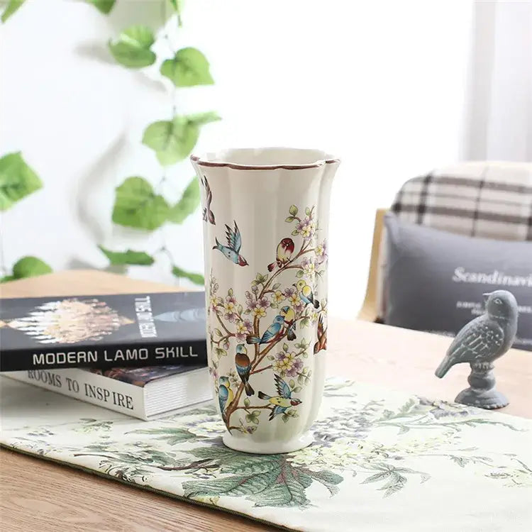 A tall cream bird butterfly porcelain vase with fluted rim and colorful hand-painted decorbites bird butterfly design