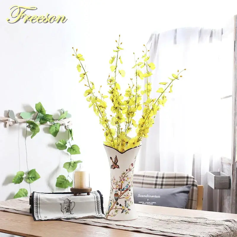 White ceramic bird butterfly porcelain vase with hand-painted floral design holding yellow artificial flowers for decorbites decor