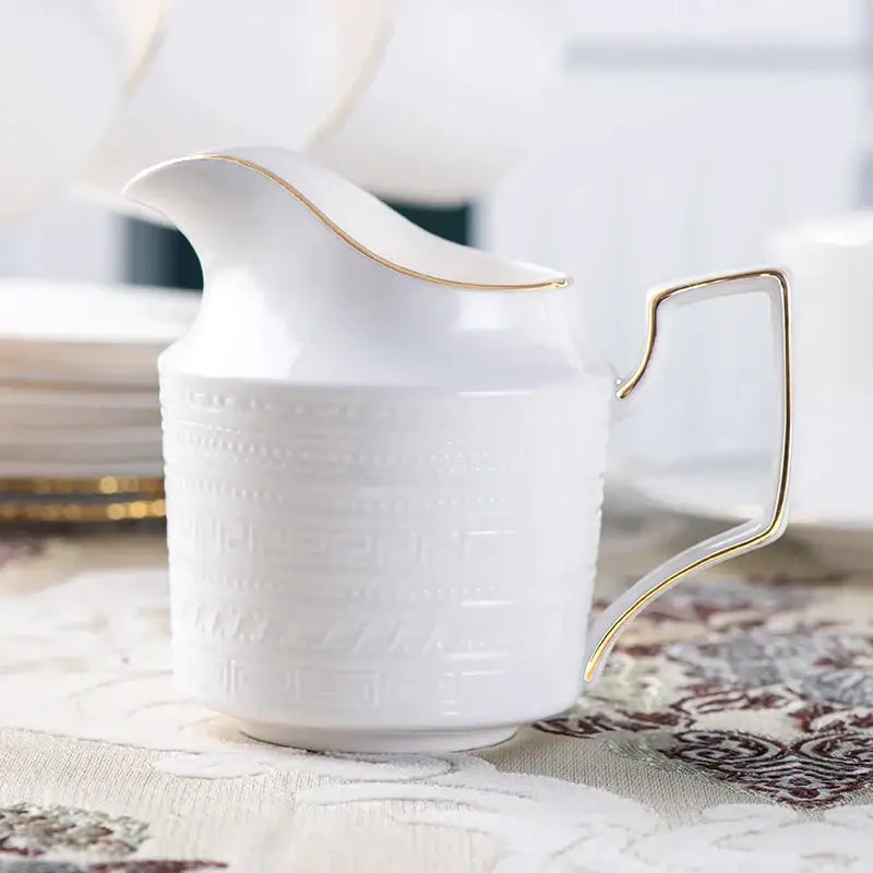 White ceramic creamer with gold trim and embossed pattern from british white tea set decorbites bone porcelain