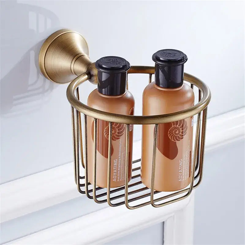 Brass wall-mounted shower caddy holding two amber bottles in decorbites bronze bathroom accessories set bathroom decor