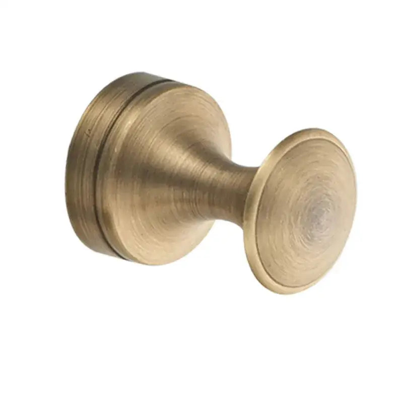 Antique brass-finished round knob with brushed metallic surface and concentric grooves in decorbites bronze bathroom hardware set